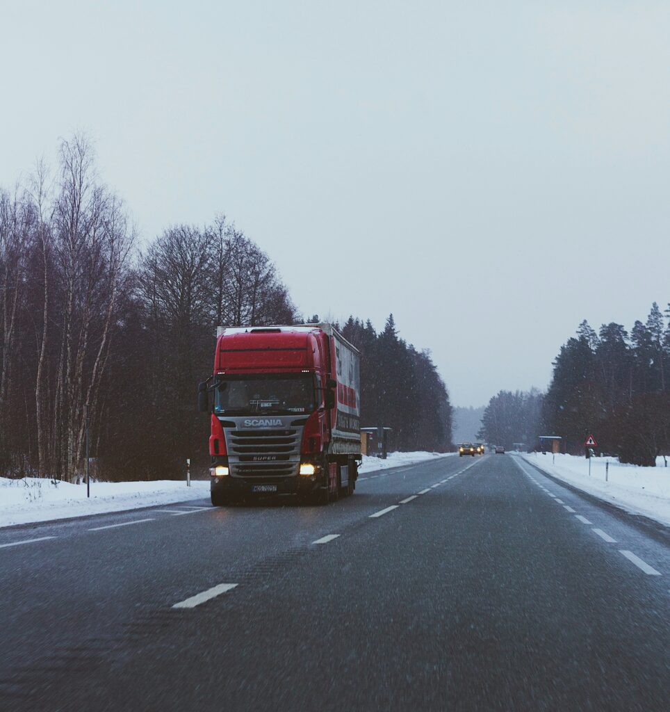 truck driving down a wintery road